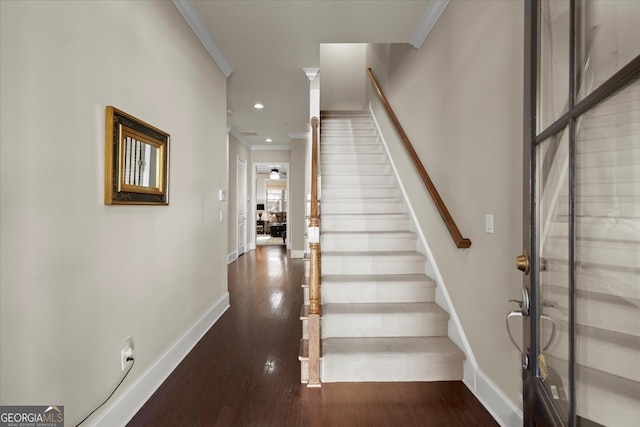 entrance foyer with crown molding and dark wood-type flooring