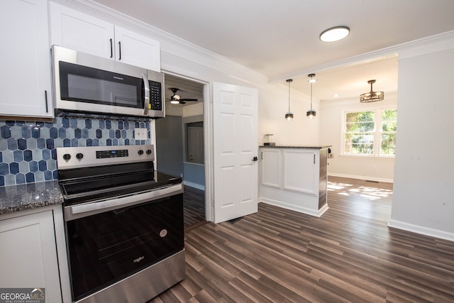 kitchen with pendant lighting, crown molding, decorative backsplash, white cabinetry, and stainless steel appliances