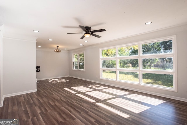 empty room featuring ceiling fan, dark hardwood / wood-style flooring, and ornamental molding