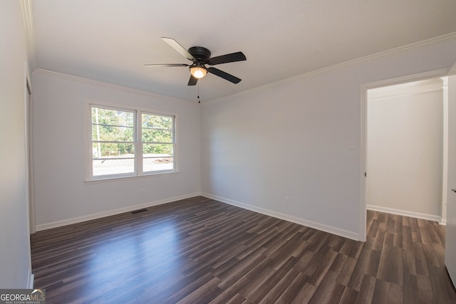 empty room with ceiling fan, crown molding, and dark wood-type flooring