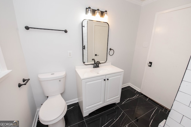 bathroom with crown molding, vanity, and toilet