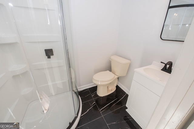 bathroom featuring tile patterned flooring, vanity, toilet, and a shower with shower door