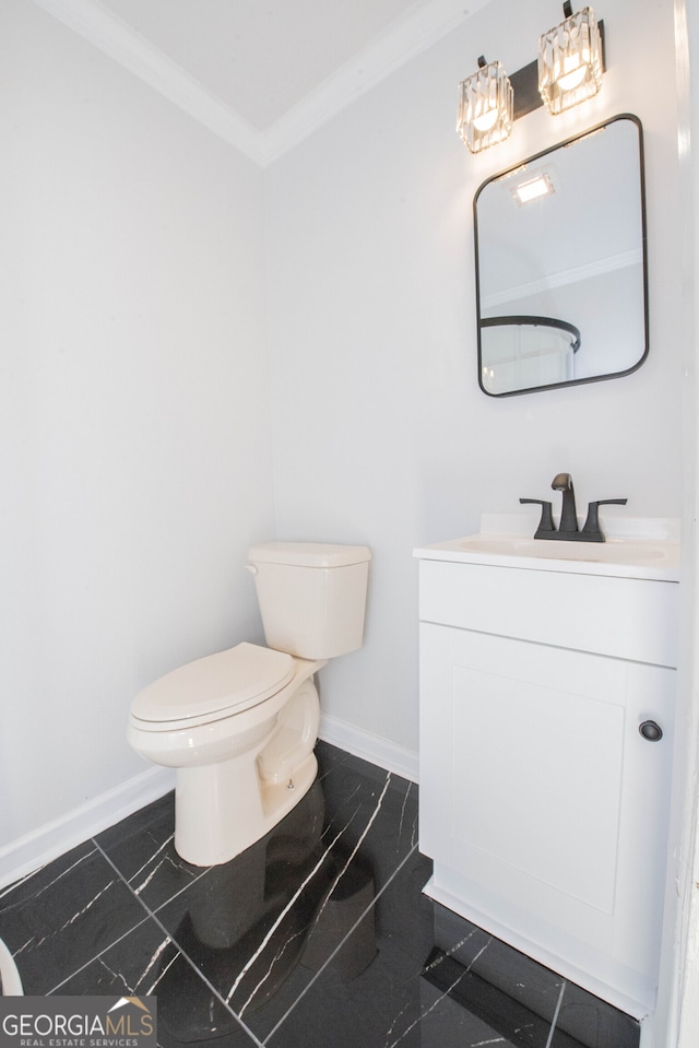 bathroom with tile patterned flooring, vanity, toilet, and crown molding