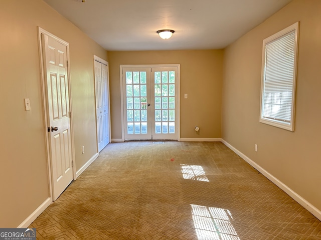 doorway featuring french doors and light colored carpet