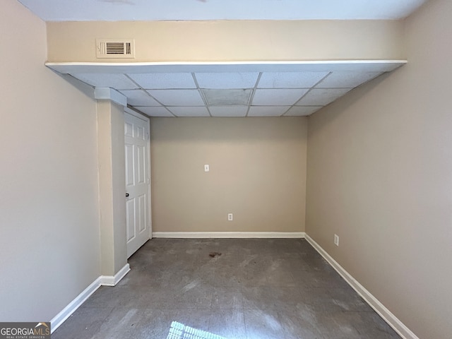 empty room featuring a drop ceiling