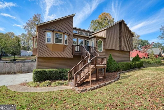 rear view of house featuring a yard