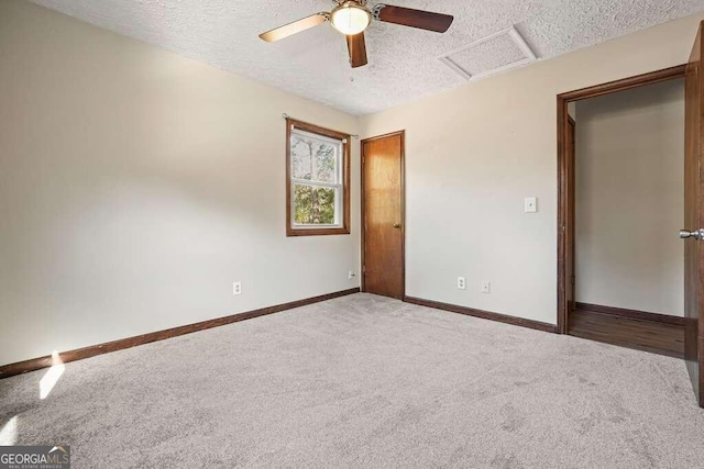 unfurnished bedroom with ceiling fan, carpet floors, and a textured ceiling