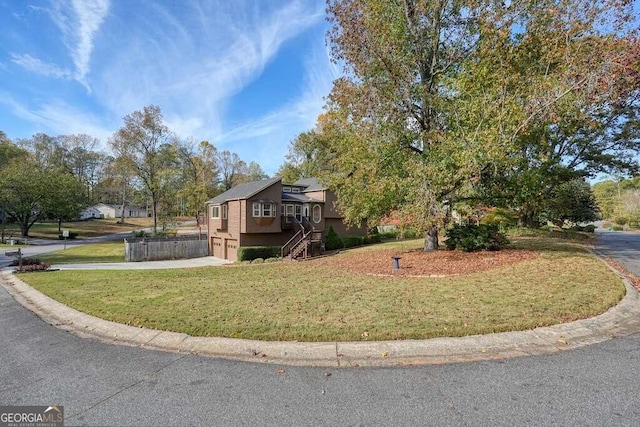 view of front of property featuring a front lawn and a garage