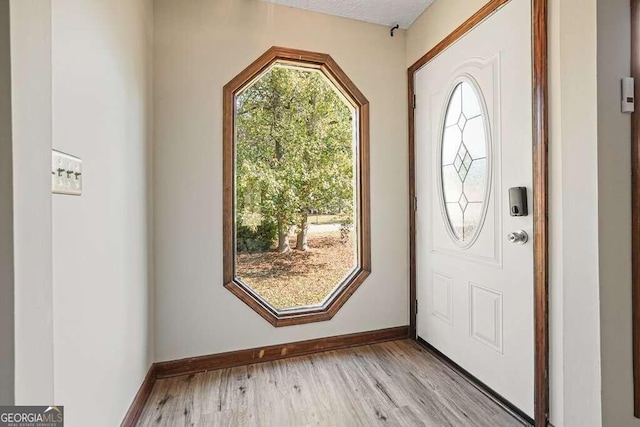 entrance foyer featuring light hardwood / wood-style floors and a textured ceiling