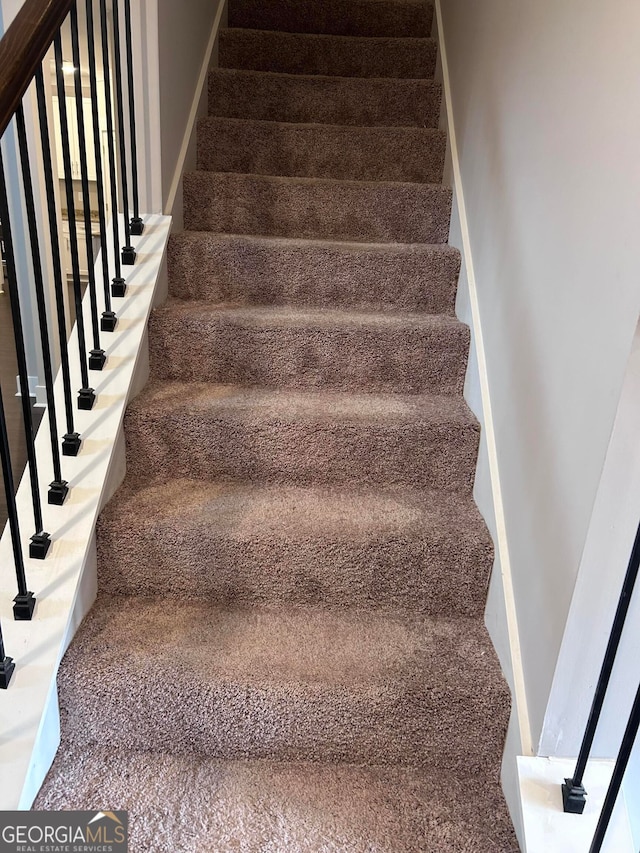 stairs featuring carpet