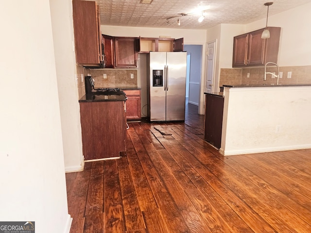 kitchen with hanging light fixtures, a textured ceiling, tasteful backsplash, dark hardwood / wood-style flooring, and stainless steel fridge with ice dispenser