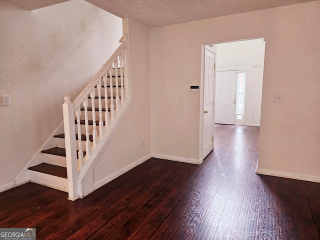 stairs featuring hardwood / wood-style flooring