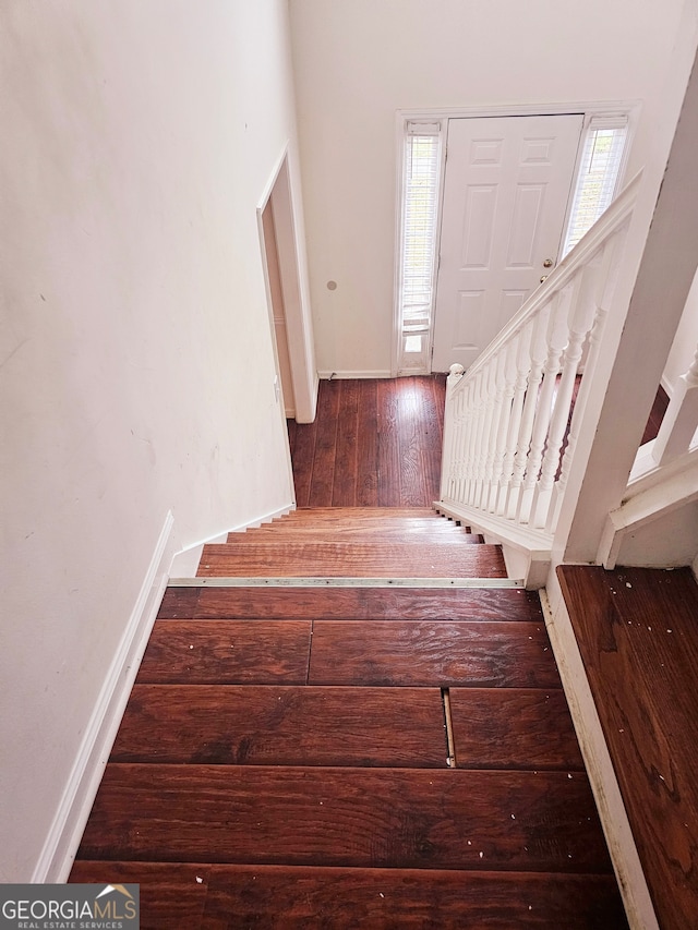 stairway with hardwood / wood-style flooring