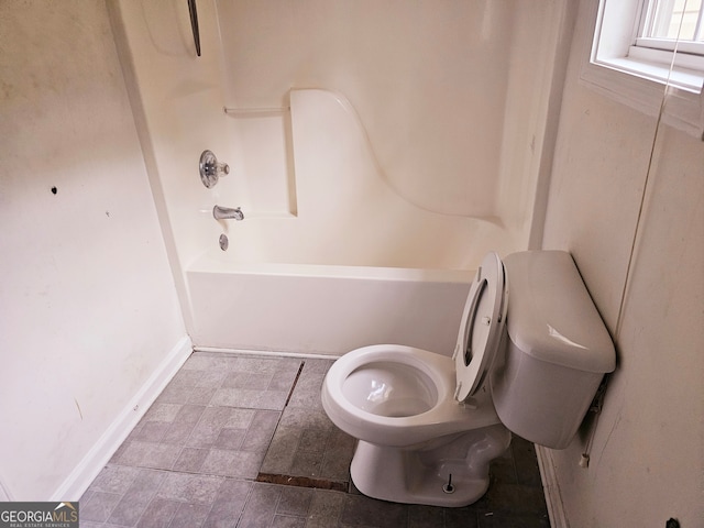 bathroom with toilet and tub / shower combination