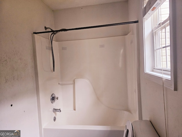 bathroom featuring washtub / shower combination