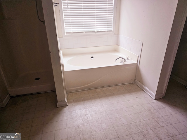 bathroom featuring independent shower and bath