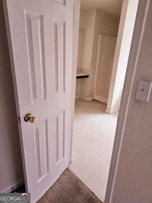 corridor with light tile patterned floors