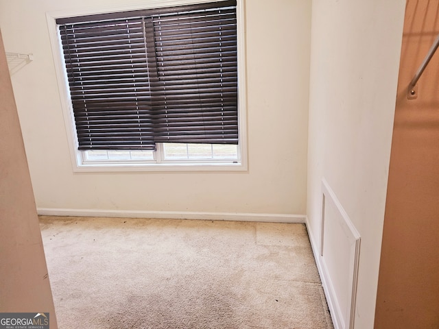 carpeted spare room with a healthy amount of sunlight