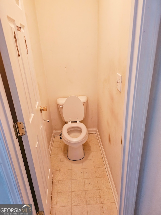 bathroom featuring tile patterned floors and toilet