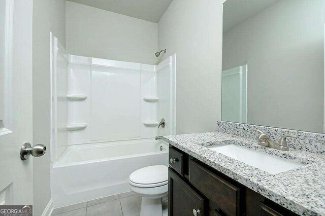 full bathroom featuring tile patterned floors, toilet,  shower combination, and vanity