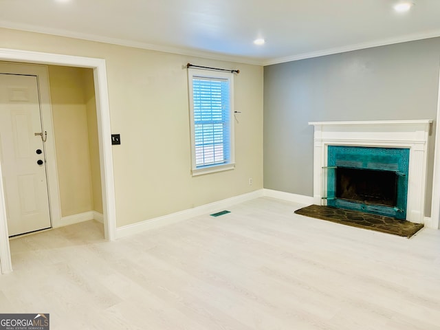 unfurnished living room with crown molding and light hardwood / wood-style flooring