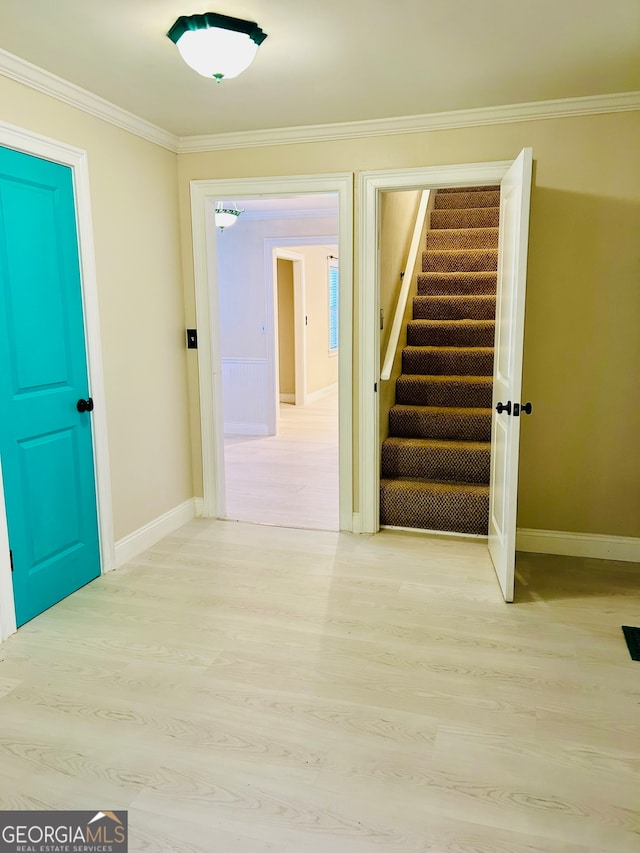 interior space with light hardwood / wood-style floors and crown molding