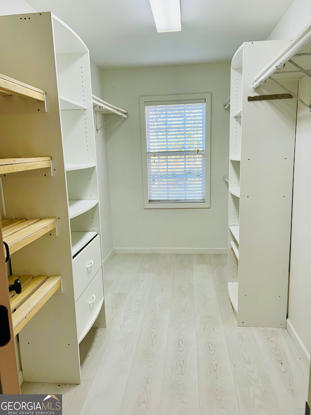 spacious closet featuring light wood-type flooring