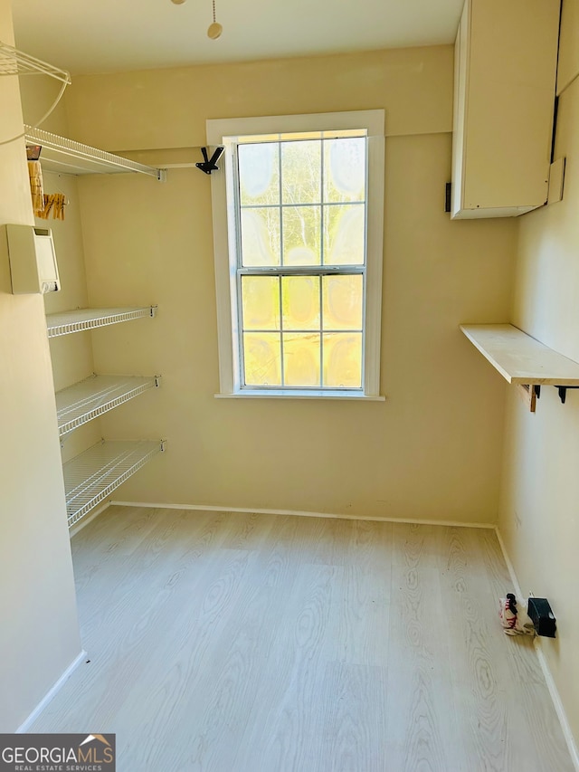 spacious closet with light hardwood / wood-style floors