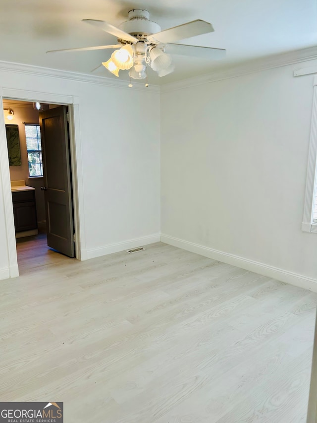 unfurnished room featuring ceiling fan, light hardwood / wood-style flooring, and crown molding