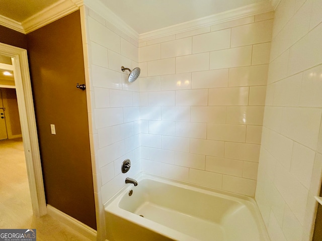 bathroom with ornamental molding and tiled shower / bath