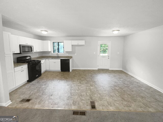 kitchen featuring black appliances, wood-type flooring, white cabinetry, and sink