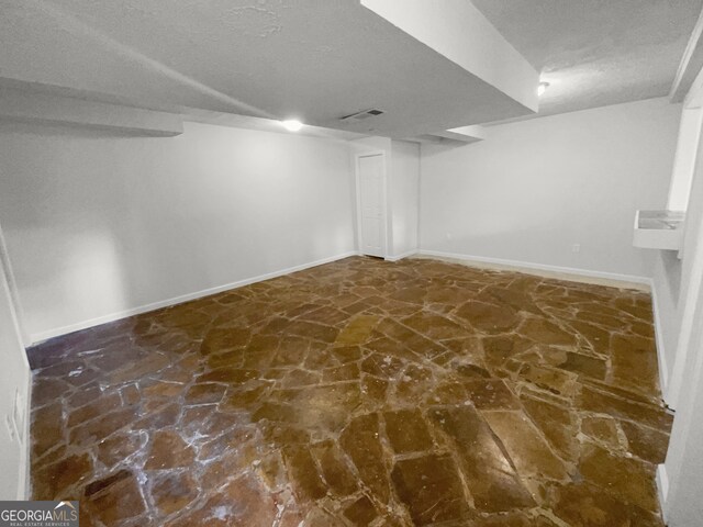 basement with a textured ceiling