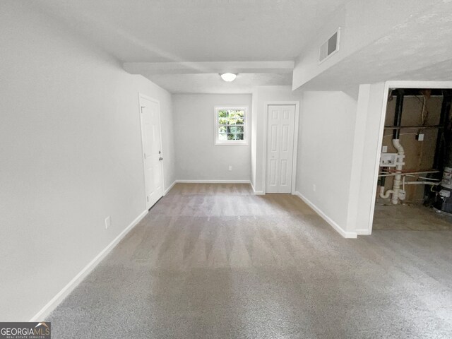 carpeted spare room with a textured ceiling