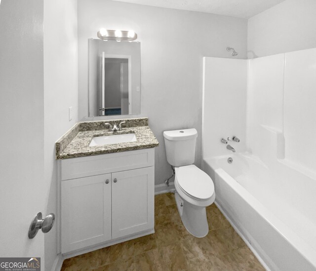 full bathroom featuring vanity, bathtub / shower combination, and toilet