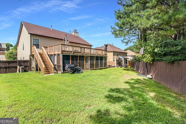 view of yard with a wooden deck and a storage shed