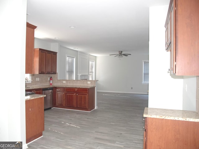 kitchen with ceiling fan, dishwasher, dark hardwood / wood-style flooring, backsplash, and kitchen peninsula