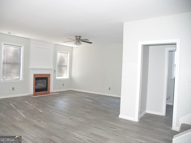 unfurnished living room with dark hardwood / wood-style floors and ceiling fan