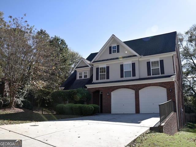 view of front of house with a garage, brick siding, and driveway