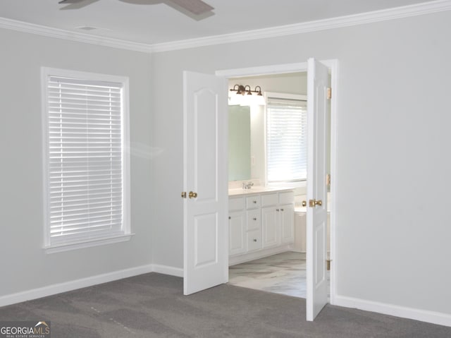 unfurnished bedroom featuring carpet flooring, connected bathroom, crown molding, and ceiling fan