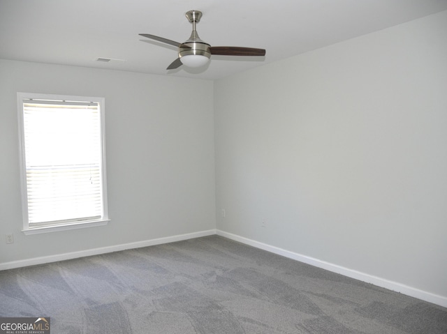 unfurnished room featuring carpet, plenty of natural light, and ceiling fan