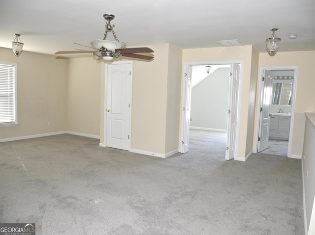 unfurnished room featuring ceiling fan and light carpet