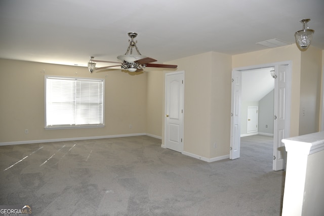 carpeted empty room featuring ceiling fan and lofted ceiling