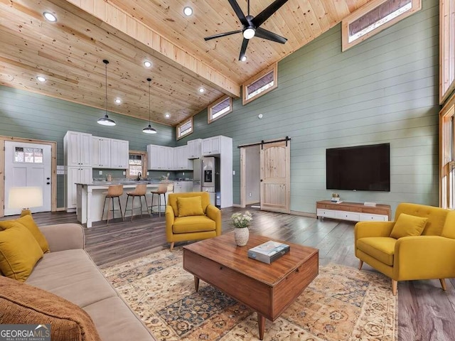 living room featuring wooden ceiling, a barn door, high vaulted ceiling, beamed ceiling, and hardwood / wood-style floors