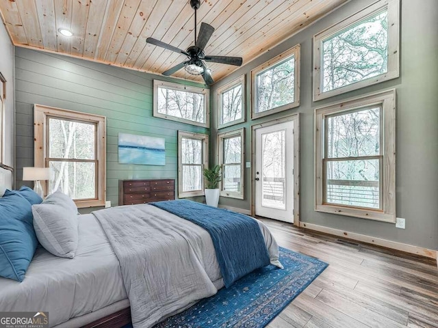 bedroom with access to exterior, ceiling fan, high vaulted ceiling, wood ceiling, and light wood-type flooring