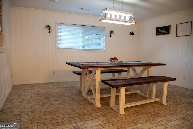 dining area featuring crown molding