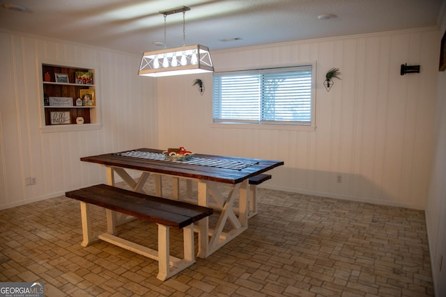 dining room featuring crown molding