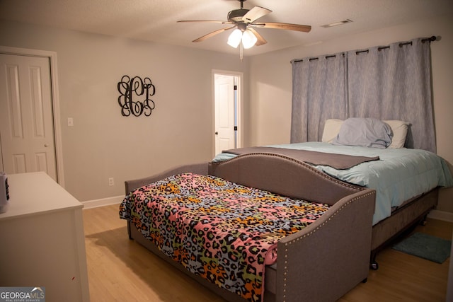 bedroom with ceiling fan and light wood-type flooring