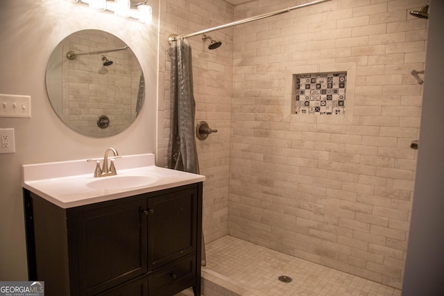 bathroom featuring walk in shower and vanity