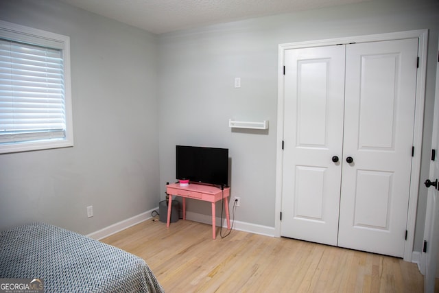 bedroom featuring light wood-type flooring and a closet