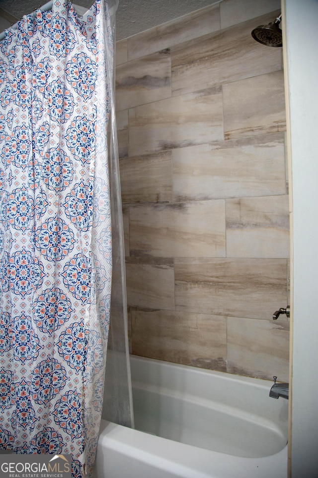 bathroom with shower / bath combo with shower curtain